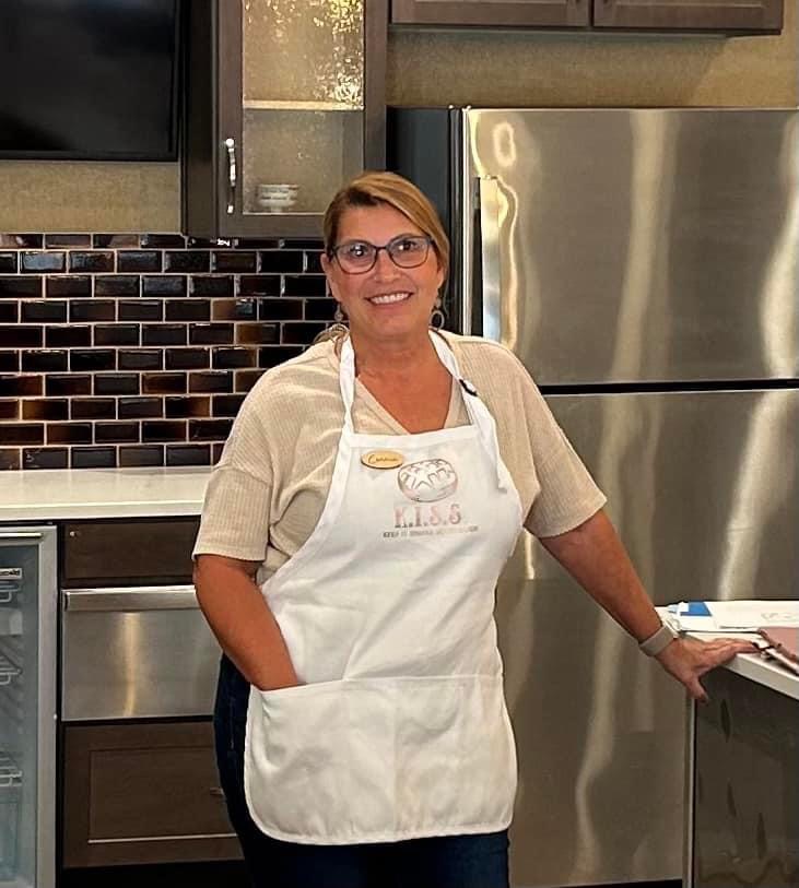 Connie in her kitchen wearing an apron, ready to teach sourdough baking